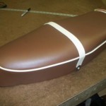 Vespa bench seat redo. Brown and white vinyl for a pink scooter.
