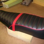 1976 motoguzzi seat redo in Black and red. New passenger strap made to use.