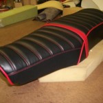 1976 motoguzzi seat redo in Black and red. New passenger strap made to use.