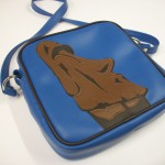 Moi Easter island monlith on a square vinyl-lux bag.